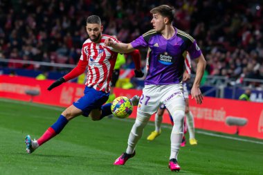 Madrid, Spain- January 21, 2023: Soccer match between Atletico de Madrid and Real Valladolid at Civitas Metropolitano. Yannick Carrasco fights for the ball on the field.