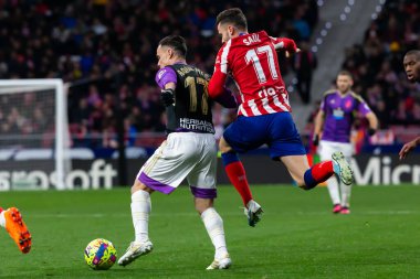 Madrid, Spain- January 21, 2023: Soccer match between Atletico de Madrid and Real Valladolid at Civitas Metropolitano. Saul iguez fights for the ball on the field.