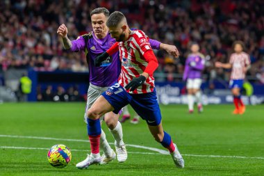 Madrid, Spain- January 21, 2023: Soccer match between Atletico de Madrid and Real Valladolid at Civitas Metropolitano. Yannick Carrasco fights for the ball on the field.