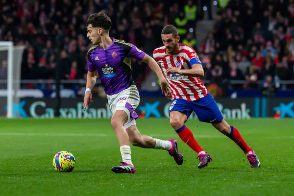 Madrid, Spain- January 21, 2023: Soccer match between Atletico de Madrid and Real Valladolid at Civitas Metropolitano. Koke Resurreccion fights for the ball with an opponent.