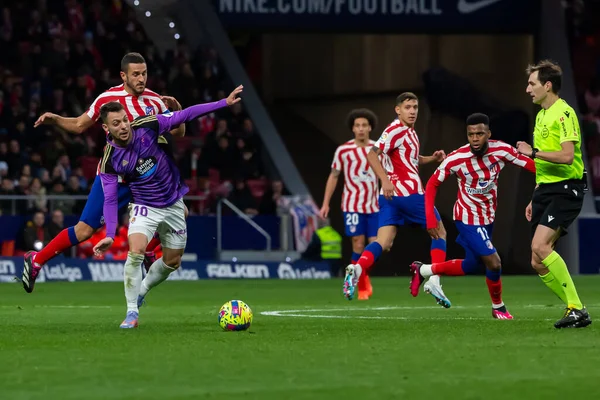 Madrid, Spain- January 21, 2023: Soccer match between Atletico de Madrid and Real Valladolid at Civitas Metropolitano. Koke Resurreccion fights for the ball with an opponent.