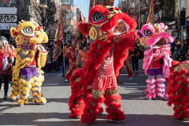 Madrid, Spain- January 21, 2023: Parade to celebrate the Chinese New Year through the streets of Madrid. Chinese citizens celebrate the year of the rabbit with typical costumes and oriental dances.