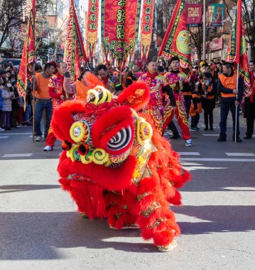 Madrid, Spain- January 21, 2023: Parade to celebrate the Chinese New Year through the streets of Madrid. Chinese citizens celebrate the year of the rabbit with typical costumes and oriental dances.