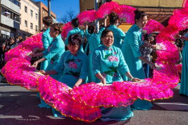 Madrid, Spain- January 21, 2023: Parade to celebrate the Chinese New Year through the streets of Madrid. Chinese citizens celebrate the year of the rabbit with typical costumes and oriental dances.