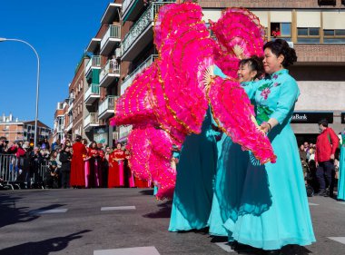 Madrid, Spain- January 21, 2023: Parade to celebrate the Chinese New Year through the streets of Madrid. Chinese citizens celebrate the year of the rabbit with typical costumes and oriental dances.