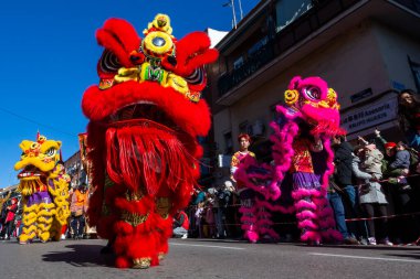 Madrid, Spain- January 21, 2023: Parade to celebrate the Chinese New Year through the streets of Madrid. Chinese citizens celebrate the year of the rabbit with typical costumes and oriental dances.