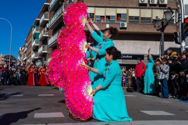Madrid, Spain- January 21, 2023: Parade to celebrate the Chinese New Year through the streets of Madrid. Chinese citizens celebrate the year of the rabbit with typical costumes and oriental dances.