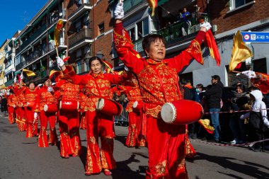 Madrid, Spain- January 21, 2023: Parade to celebrate the Chinese New Year through the streets of Madrid. Chinese citizens celebrate the year of the rabbit with typical costumes and oriental dances.