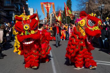 Madrid, Spain- January 21, 2023: Parade to celebrate the Chinese New Year through the streets of Madrid. Chinese citizens celebrate the year of the rabbit with typical costumes and oriental dances.
