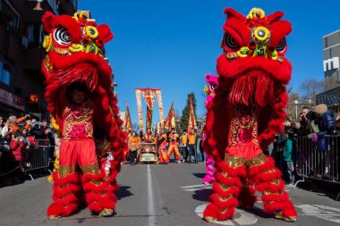 Madrid, Spain- January 21, 2023: Parade to celebrate the Chinese New Year through the streets of Madrid. Chinese citizens celebrate the year of the rabbit with typical costumes and oriental dances.