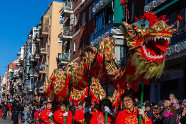 Madrid, Spain- January 21, 2023: Parade to celebrate the Chinese New Year through the streets of Madrid. Chinese citizens celebrate the year of the rabbit with typical costumes and oriental dances.
