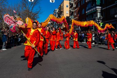 Madrid, Spain- January 21, 2023: Parade to celebrate the Chinese New Year through the streets of Madrid. Chinese citizens celebrate the year of the rabbit with typical costumes and oriental dances.