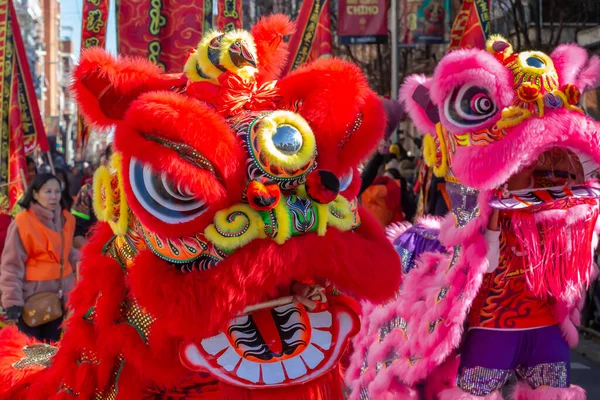 Madrid, Spain- January 21, 2023: Parade to celebrate the Chinese New Year through the streets of Madrid. Chinese citizens celebrate the year of the rabbit with typical costumes and oriental dances.