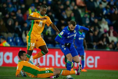 Madrid, Spain- January 28, 2023: Soccer match between Real Betis balonpie and Getafe F.C in Madrid. Betis player William Carvalho fights with an opponent for the ball.
