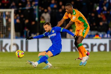 Madrid, Spain- January 28, 2023: Soccer match between Real Betis balonpie and Getafe F.C in Madrid. The Betis player Sergio Canales fights with an opponent for the ball.