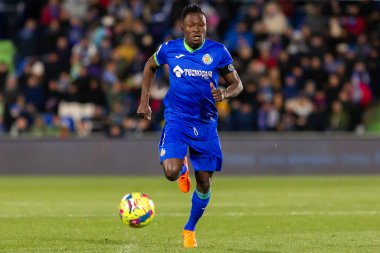 Madrid, Spain- January 28, 2023: Soccer match between Real Betis balonpie and Getafe F.C in Madrid. The Getafe player Djen Dakoman fights with an opponent for the ball.
