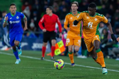 Madrid, Spain- January 28, 2023: Soccer match between Real Betis balonpie and Getafe F.C in Madrid. The Betis player Luiz Enrique fights with an opponent for the ball.