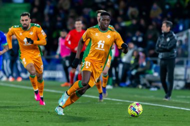 Madrid, Spain- January 28, 2023: Soccer match between Real Betis balonpie and Getafe F.C in Madrid. The Betis player Luiz Enrique fights with an opponent for the ball.