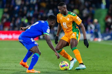 Madrid, Spain- January 28, 2023: Soccer match between Real Betis balonpie and Getafe F.C in Madrid. The Betis player Luiz Enrique fights with an opponent for the ball.