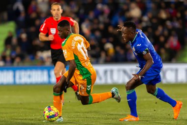Madrid, Spain- January 28, 2023: Soccer match between Real Betis balonpie and Getafe F.C in Madrid. The Betis player Luiz Enrique fights with an opponent for the ball.