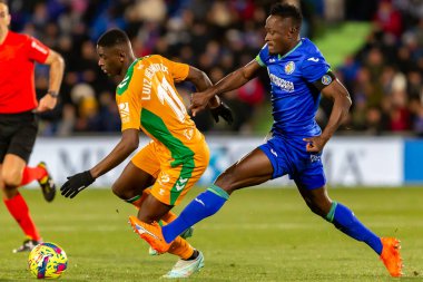 Madrid, Spain- January 28, 2023: Soccer match between Real Betis balonpie and Getafe F.C in Madrid. The Betis player Luiz Enrique fights with an opponent for the ball.