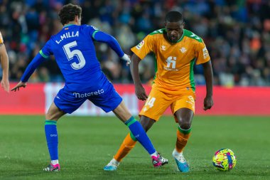 Madrid, Spain- January 28, 2023: Soccer match between Real Betis balonpie and Getafe F.C in Madrid. The Betis player Sergio Canales fights with an opponent for the ball.