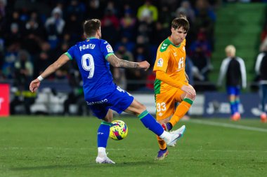 Madrid, Spain- January 28, 2023: Soccer match between Real Betis balonpie and Getafe F.C in Madrid. Juan Miranda fights for a ball on the field.