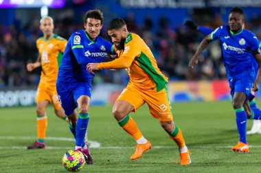 Madrid, Spain- January 28, 2023: Soccer match between Real Betis balonpie and Getafe F.C in Madrid. The Betis player Nabil Fekir fights with an opponent for the ball.