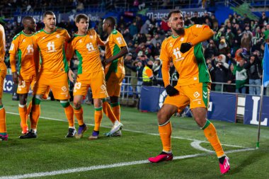 Madrid, Spain- January 28, 2023: Soccer match between Real Betis balonpie and Getafe F.C in Madrid. The Betis player Borja Iglesias celebrates a goal with his teammates and the fans.