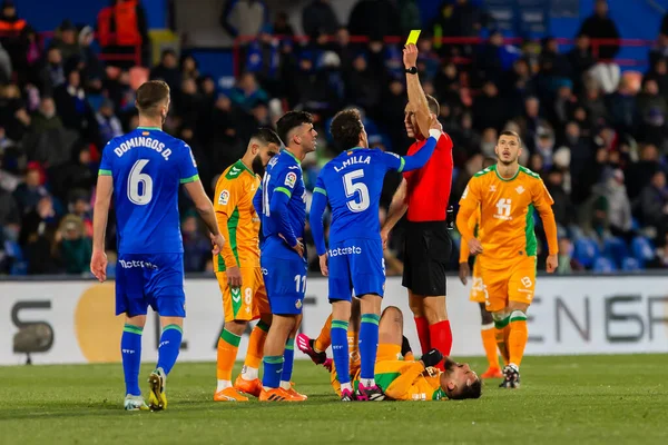 Madrid, Spain- January 28, 2023: Soccer match between Real Betis balonpie and Getafe F.C in Madrid. The players complain to the referee for a foul during the match.