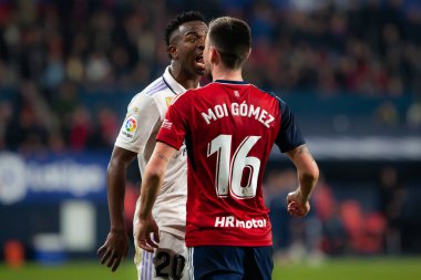 Madrid, Spain- February 18, 2023: League match between Real Madrid and Osasuna in Pamplona. Vinicius Jr. fights with an opponent. Football games. Real Madrid player. clipart