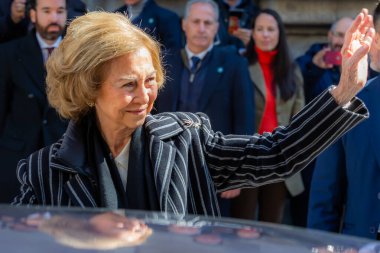 Madrid, Spain- March 3, 2023: Queen Emeritus Sofa visits the church of Cristo de Medinacelli in Madrid. The queen greets the people waiting for her arrival at the church.