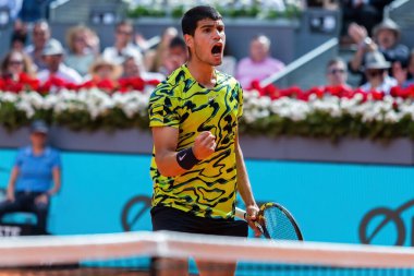 Madrid, Spain- April 28.2023: Tennis match at the Mutua Madrid Open between Carlos Alcaraz and Emil Ruusuvuori with the victory of the Spanish. ATP match. Number 2 in the ATP ranking. clipart