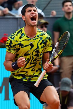 Madrid, Spain- April 28.2023: Tennis match at the Mutua Madrid Open between Carlos Alcaraz and Emil Ruusuvuori with the victory of the Spanish. ATP match. Number 2 in the ATP ranking. clipart