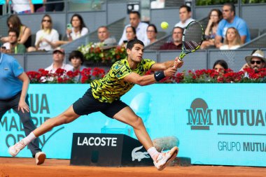 Madrid, Spain- April 28.2023: Tennis match at the Mutua Madrid Open between Carlos Alcaraz and Emil Ruusuvuori with the victory of the Spanish. ATP match. Number 2 in the ATP ranking. clipart