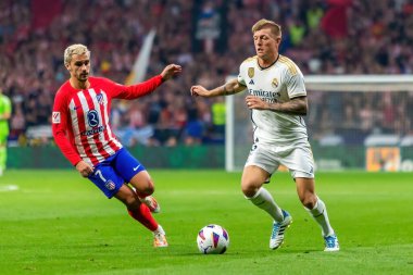 Madrid, Spain- September 24, 2023: League match between Atletico de Madrid and Real Madrid. Toni Kross with the ball. Football players. Victory for Atletico de Madrid. clipart