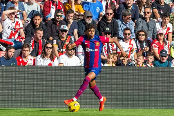 stock image Madrid, Spain- November 25, 2023: League match between Rayo Vallecano and F.C Barcelona in Madrid. Lamine Yamal with the ball. Football players.