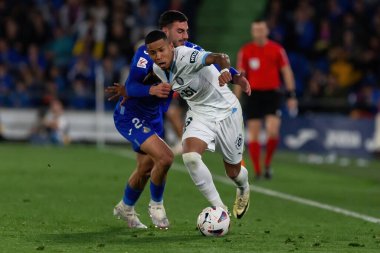 Madrid, Spain- March 16, 2024: League match between Getafe f.c and Girona f.c played in Madrid. Savio Moreira with the ball. Professional league. Football players. clipart