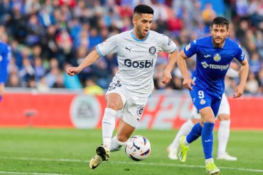 Madrid, Spain- March 16, 2024: League match between Getafe f.c and Girona f.c played in Madrid. Yan Couto with the ball. Professional league. Football players. clipart