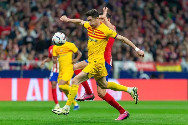 stock image Madrid, Spain- March 17, 2024: League match between Atletico de Madrid and Barcelona F.C in Madrid. Robert Lewandowski with the ball. Football players.