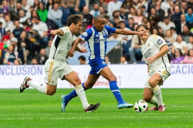 Madrid, Spain- March 23, 2024: Solidarity match between Real Madrid Leyendaa and Porto Vintage at the Santiago Bernabeu. Raul Gonzalez playing soccer in the field. Raul Gonzalez with the ball. clipart