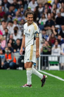 Madrid, Spain- March 23, 2024: Solidarity match between Real Madrid Leyendaa and Porto Vintage at the Santiago Bernabeu. Raul Gonzalez playing soccer in the field. Raul Gonzalez with the ball. clipart