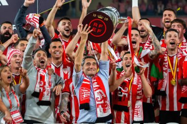 Seville, Spain- April 6, 2024: Final of the Copa del Rey soccer match between Athletic Club de Bilbao and Real Mallorca. Ernesto Valverde celebrates the victory. clipart