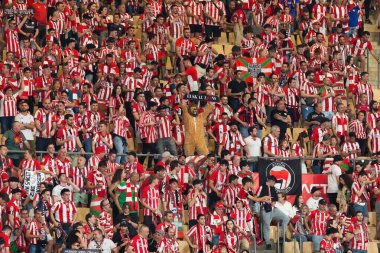 Seville, Spain- April 6, 2024: Final of the Copa del Rey soccer match between Athletic Club de Bilbao and Real Mallorca. Athletic Club fans during the match. clipart
