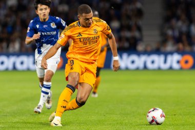 San Sebastian, Spain - September 14, 2024: League match between Real Sociedad and Real Madrid, played in San Sebastian. Kylian Mbappe with the ball. Real Madrid players. clipart