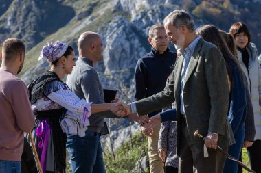 Oviedo, Spain - October 24, 2024: The King and Queen of Spain and their daughters visit the town of Sotres in the Picos de Europa as an exemplary town in 2024. The Princess of Asturias walks through the streets of Sotres. clipart