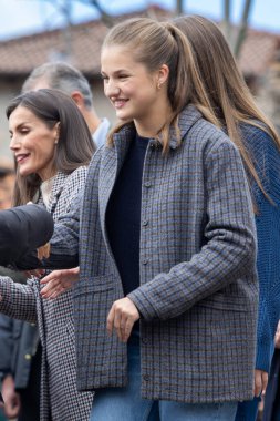 Oviedo, Spain - October 24, 2024: The King and Queen of Spain and their daughters visit the town of Sotres in the Picos de Europa as an exemplary town in 2024. The Princess of Asturias walks through the streets of Sotres. clipart