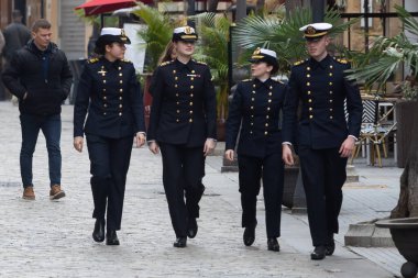 Cadiz, Spain - January 10, 2025: The Princess of Asturias goes out to eat with some shipmates at a restaurant in the center of Cadiz before boarding. Princess of Asturias in uniform. clipart