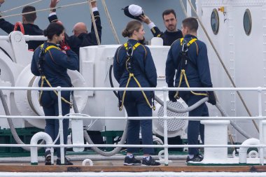 Cadiz, Spain - January 11, 2025: The Princess of Asturias boards the training ship Juan Sebastian El Cano as a naval keeper in the port of Cadiz. The King and Queen of Spain bid farewell to their daughter from the sea. clipart