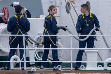 Cadiz, Spain - January 11, 2025: The Princess of Asturias boards the training ship Juan Sebastian El Cano as a naval keeper in the port of Cadiz. The King and Queen of Spain bid farewell to their daughter from the sea. clipart